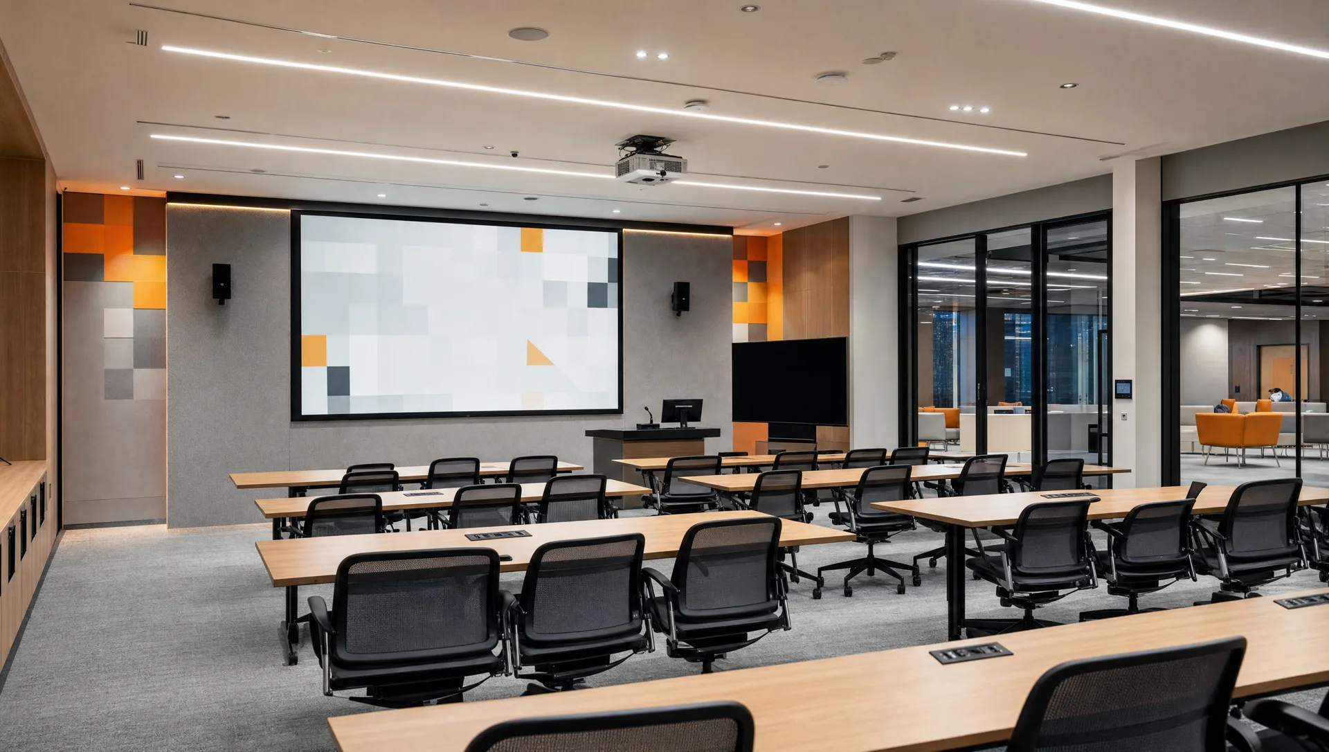Sala de presentación moderna con pantalla integrada y puestos de trabajo